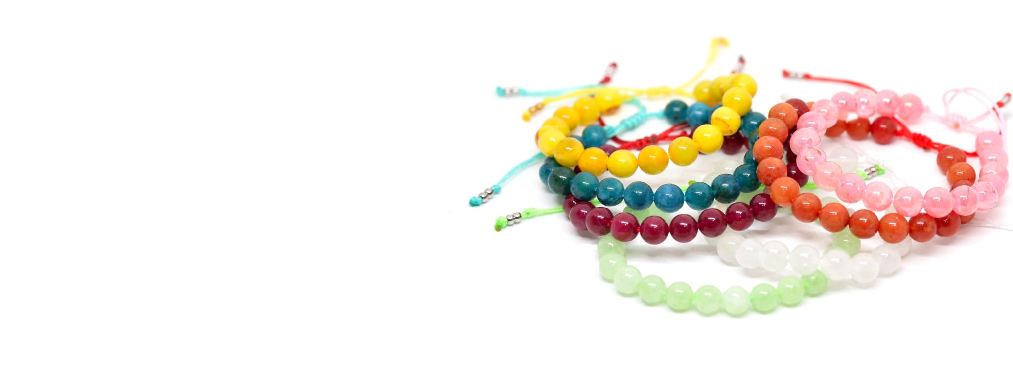 Colorful beaded bracelets on a white background